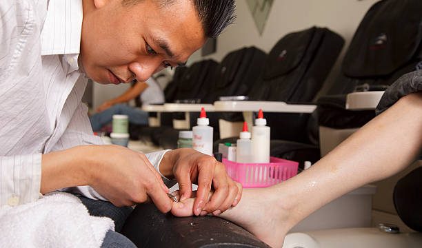 A manicurist working in a nail salon.