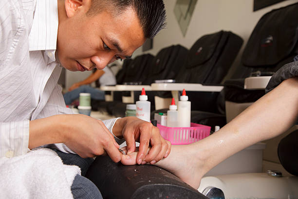 A manicurist working in a nail salon.